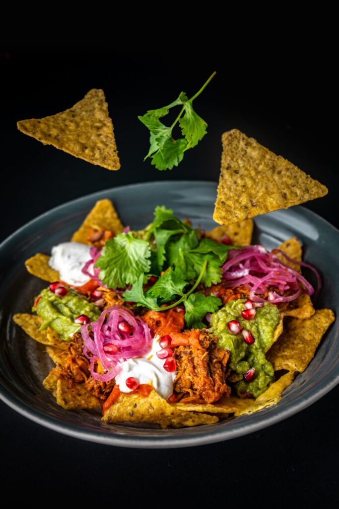 NACHOSY Z SZARPANĄ WIEPRZOWINĄ/sos pomidorowy z dodatkiem
chipotle/czerwona marynowana cebula/guacamole/kolendra